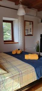 a bedroom with a large bed with yellow pillows on it at Apartments Elena & Damir in Vis