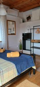 a bedroom with a bed with a blue blanket at Apartments Elena & Damir in Vis