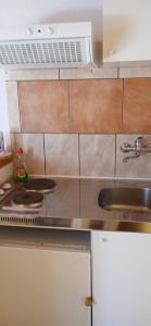 a kitchen with a stove and a sink at Apartments Elena & Damir in Vis