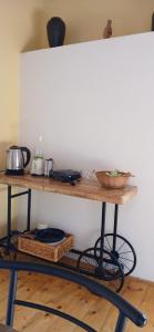 a wooden shelf with pots and pans on it at Apartments Elena & Damir in Vis