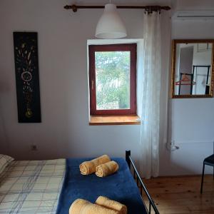 a bedroom with a bed with towels on it at Apartments Elena & Damir in Vis