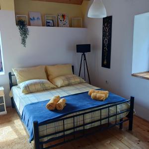 a bedroom with a bed with towels on it at Apartments Elena & Damir in Vis