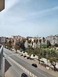 a city street with cars driving down a road at appartement de luxe réservée aux familles in Meknès