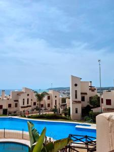 a large swimming pool in front of some buildings at Heaven's Door in Bahia de Casares
