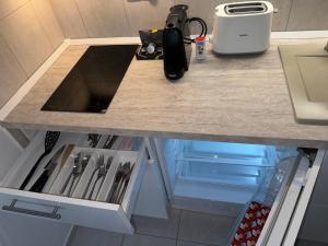 a kitchen counter with an open drawer in a kitchen at Goldvilla Apartman in Zalakaros +23 photos