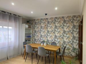 a dining room with a wooden table and chairs at Villa Lila - planta 1ª in Pontevedra