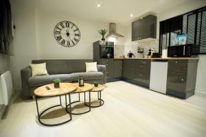 a living room with a couch and a table at Le Carolo Ducal in Charleville-Mézières +17 photos