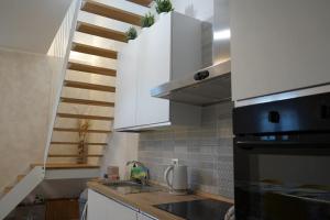 a kitchen with a sink and a stove top oven at Casa Ella in Cupra Marittima