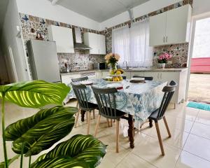 a kitchen with a table and chairs in a room at Buenavista - CHC - Mar Azul in Buenavista del Norte