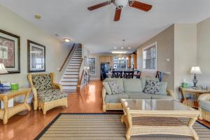 a living room with a couch and a table at Jacks Beach House by Carolina Beach Realty in Carolina Beach