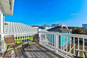 a deck with two chairs and a blue bench on it at Jacks Beach House by Carolina Beach Realty in Carolina Beach +32 photos