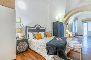 a bedroom with a large bed with orange pillows at Yellow - Lecce Selection in Lecce