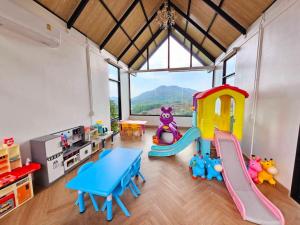 a childrens play room with a table and play equipment at Mountain view resort samoeng in Chiang Mai