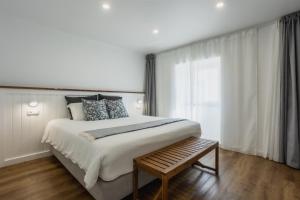 a bedroom with a large bed and a window at São Jorge Holiday Homes in Velas