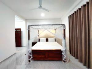 a bed with a canopy in a room at Y&Y villa in Narigama +10 photos