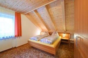 Postel nebo postele na pokoji v ubytování Apartments Ferdigg