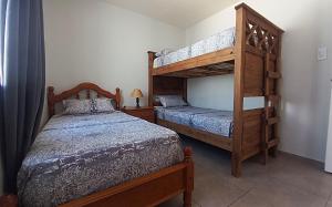 two beds in a bedroom with a bunk bed at Sueños Del Pilar II # Mendoza # Casa Depto en G Cruz # Estacionamiento # Bodegas in Mendoza +24 photos
