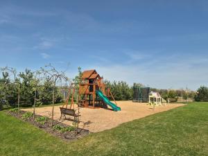 a playground with a slide and a play structure at Ostoja Rodzinna in Giżycko