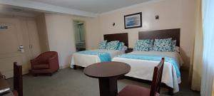 Postel nebo postele na pokoji v ubytování Hotel Novalux