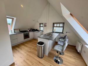 a kitchen with white cabinets and a counter top at Severn View Barn -5 min from M5, J14 in Thornbury