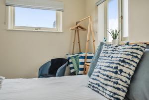 a bedroom with a bed with a pillow and a window at Coast View in Bideford