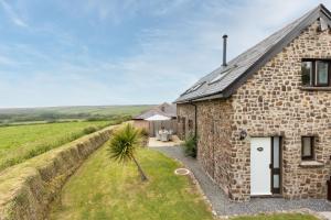 a stone cottage with a pathway leading to the front door at Coast View in Bideford