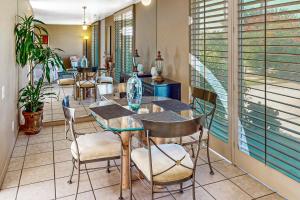 a dining room with tables and chairs and a window at Desert Serenity Getaway in Palm Desert