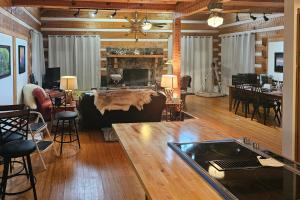 a living room with a couch and a fireplace at Rocky Knob Getaway in Scaly Mountain