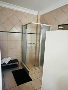 a shower with a glass door in a bathroom at B3 Self-catering accommodation Potch in Potchefstroom +16 photos