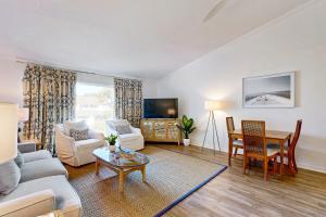 a living room with a couch and a table at 40 Lagoon Villa in Isle of Palms
