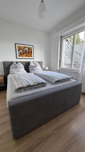 a large bed in a bedroom with a large window at Casa Angela in Orselina