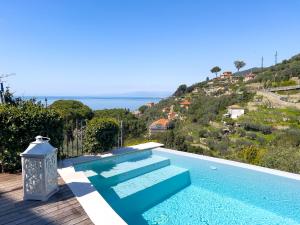 a swimming pool with a view of the ocean at Villa Rosa in Camogli