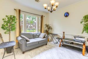 a living room with a couch and a tv at Home 7 Mi to Energy Corridor Remote-Work Ready! in Houston