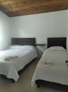 Postel nebo postele na pokoji v ubytování Cabañas hotel COLONIA SAN MIGUEL