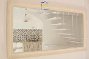 a mirror in a white room with a shelf at Mescia Alba x AP Apartment in Gallipoli