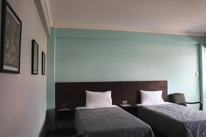 Postel nebo postele na pokoji v ubytování Kunan Hotel + 37 fotografií