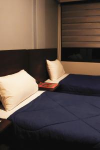 Postel nebo postele na pokoji v ubytování Kunan Hotel