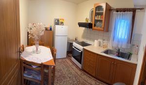 a small kitchen with a sink and a refrigerator at Arxontiko Manteio in Manteio
