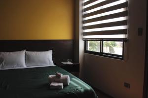 Postel nebo postele na pokoji v ubytování Kunan Hotel