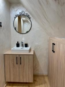 a bathroom with a sink and a mirror at Mokrogorski konaci in Mokra Gora +37 photos