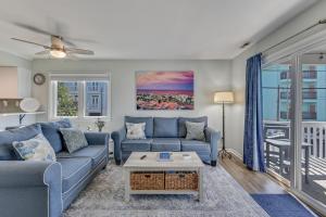 a living room with a couch and a table at The Scallop by Carolina Beach Realty in Carolina Beach