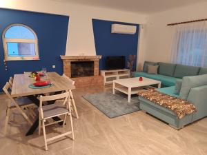 a living room with a couch and a table at Joel Apartment in Pefkali