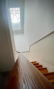 an empty room with a window and wooden stairs at Casa D'Almeida by Porto Stories in Porto +150 photos
