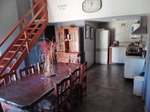 a kitchen and dining room with a table and chairs at Gianamore in Santa Teresita