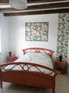 a bedroom with a bed and two night stands at Au Cœur de Lignières in Lignières-de-Touraine