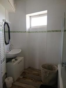 a bathroom with a tub and a sink and a window at Au Cœur de Lignières in Lignières-de-Touraine