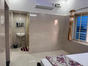 a bathroom with a shower and a toilet and a sink at SRI HARI RESIDENCy in Kanipakam