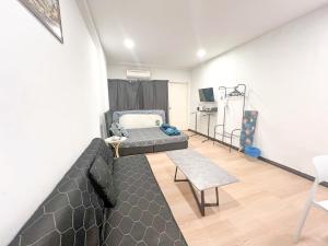a living room with a bed and a couch at KK City Api Api Block 1 Above Mcd Studio Homestay 2-3 pax in Kota Kinabalu