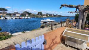 a view of a marina with a boat in the water at Super Maison de pêcheur in Le Barcarès