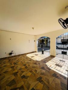 an empty room with two barred doors and a floor at Casa Completa - Cop 30 in Belém